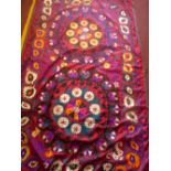 An attractive Uzbek Suzani plum silk ground embroided in bright sicks in Basma stitch, samankand.