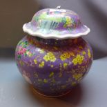 A Chinese famille verte vase and cover decorated with flora and fauna on a purple ground (a/f)
