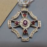 A silver pendant set with garnets