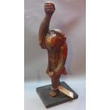 A 19th century carved mahogany figure of a monkey having glass eyes on ebonized stand.