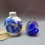 Two Chinese snuff bottles to include a Peking glass example and a blue and white porcelain example