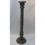 A decorative wood jardiniere stand with reeded column and circular base.