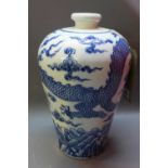 A Chinese blue and white vase decorated with a five clawed dragon chasing a pearl,