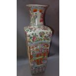A Chinese famille rose vase decorated with figures in a courtyard scene,