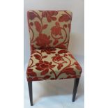 A set of six Italian designer chairs by SASA with red floral upholstery on a cream ground raised on