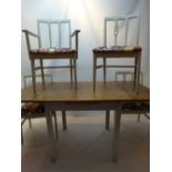 A 20th century draw leaf table with four chairs upholstered in retro 1970s prints Measures approx