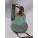 A large factory yard bell with wall mount.