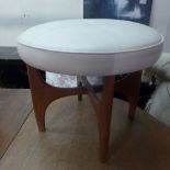 A G-Plan stool having cream leather circular top and convex shaped legs
