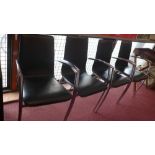 A set of four Actona black leather chairs with chrome arms and legs