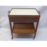 A vintage 20th century teak trolley having formica top, lift top,