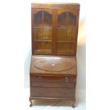 An early 20th Century mahogany bureau bookcase with two glazed doors above dropflap and three