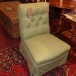 A Victorian mahogany nursing chair raised on turned legs and castors,