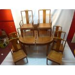 A Chinese hardwood dining table and eight chairs with two extra leaves