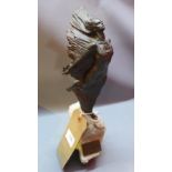 A 20th century resin sculpture of a woman on a rocky out crop, designed by Josep Bofill,