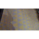 A contemporary carpet with yellow and grey triangle pattern.