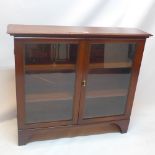 A 19th Century mahogany glass fronted bookcase, raised on carved bracket feet.