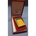 A Dupont lighter and matching cigar cutter, yellow enamelled design,