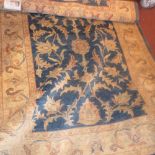 A Ziegler style carpet, foliate design over green ground, within cream border, fringed,