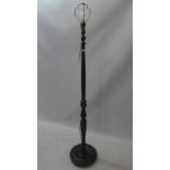 A 20th Century mahogany standard lamp with reeded column and raised on circular base.