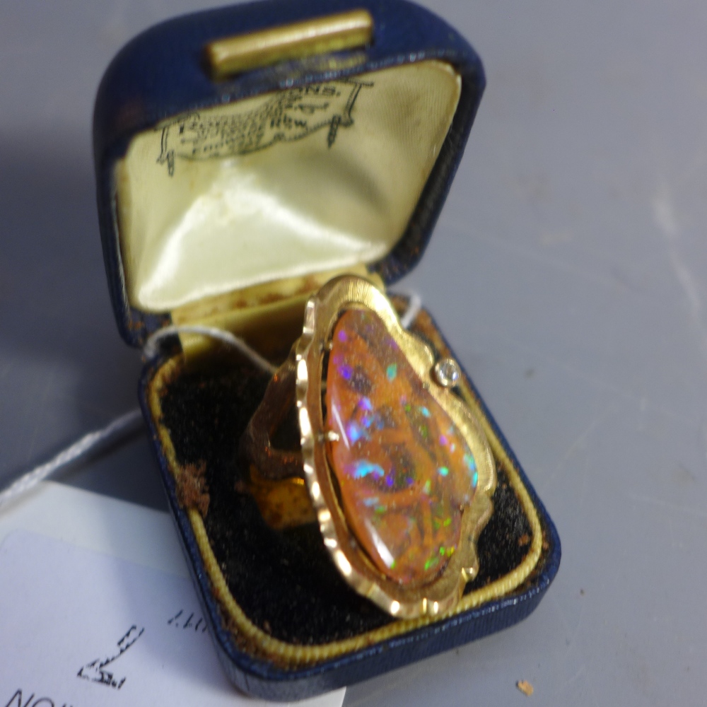 A 14ct yellow gold ring, set with fire opal and diamond within scrolling organic mount,