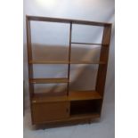 A vintage 20th Century teak display bookcase shelf unit above cupboard with sliding doors H: 168cm