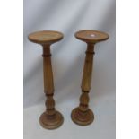 A pair of turned walnut pedestals,