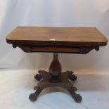 A William IV mahogany card table raised on a quatraform base terminating in lion paw feet.