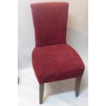 A set of six contemporary dining chairs with red checkered upholstery raised on oak legs