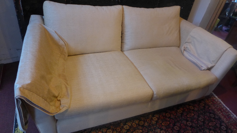 A contemporary beige two seater sofa Length 178cm x 68cm D: 98cm