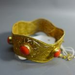 A yellow gold and filigree bracelet, applied cabuchon gem decoration,