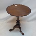 A Chippendale style mahogany tilt top table with pie crust top raised on bird cage mechanism,