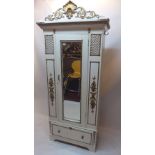 A Victorian white painted armoire with gilt painted features and mirrored door,