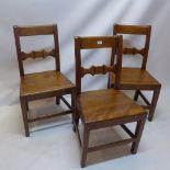 A set of three solid mahogany dining chairs.