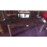 A mid 20th Century teak coffee table with oval glass top,