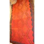 A large red Kelim rug