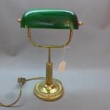 A desk lamp with green shade. H.