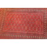 A 20th century red ground Bokhara rug.