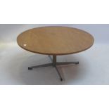 A mid 20th Century circular oak coffee table raised on chrome base.