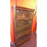 A Globe Wernicke oak four section bookcase with single drawer to base.