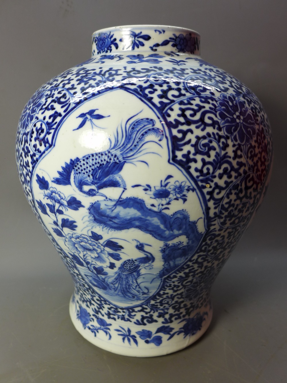 A 19th Century Chinese blue and white vase depicting scenes of flora and fauna and four character