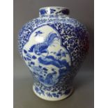 A 19th Century Chinese blue and white vase depicting scenes of flora and fauna and four character