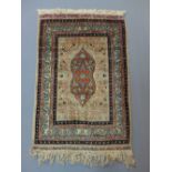 Pair of Keshan prayer rugs, floral medallions to centre over pale grey, multi-bordered,