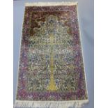 Indian part silk rug, decorated with tree of life design over cream ground and indigo border,