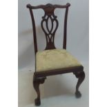 A set of six mahogany Chippendale style chairs with carved and pierced back rests and raised on