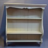 A grey painted wall hanging shelf unit.