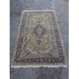 A large Indian silk carpet, central tear drop medallion over olive and spandrel ground,
