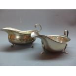 A silver sauce boat with feet, Birmingham 1930/1, marked 'S LD', together with a silver sauce boat,