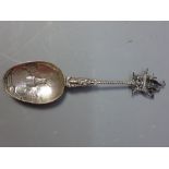 A silver spoon with barley twist handle having cerub and ship finial. The base depicting windmill.