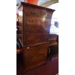 A 19th Century mahogany chest on chest with an arrangement on eight drawers and raised on carved
