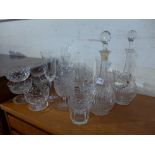 A collection of glasses and glass ware including two decanters